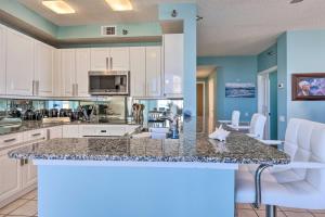 a kitchen with white cabinets and a counter top at Oceanfront Corner-Unit Condo on Perdido Key! in Pensacola