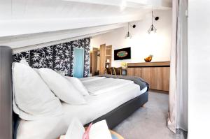 a bedroom with a large bed with white pillows at Villa Milli B&B in Rovinj
