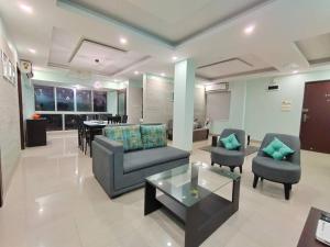a living room with two chairs and a table at Woods & Hills in Siliguri