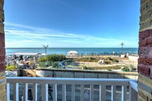 a view of the beach from a balcony at Hotel Le Rayon Vert in Étretat