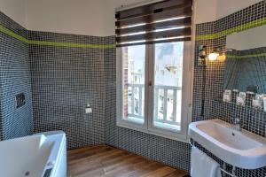 a bathroom with a sink and a window at Hotel Le Rayon Vert in Étretat
