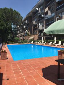 a large swimming pool in front of a building at Aurelia Antica Suites & Apartments in Rome