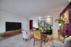 uma sala de estar com uma televisão de ecrã plano e um sofá em IMMOGROOM - Terrace - Ideal Congress - Air conditioner em Cannes