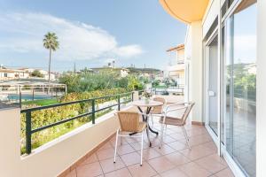 a balcony with a table and chairs and a view at Anna Αpartments II in Agia Marina Nea Kydonias