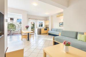 a living room with a couch and a table at Anna Αpartments II in Agia Marina Nea Kydonias