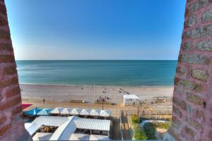 a view of the beach from a building at Hotel Le Rayon Vert in Étretat
