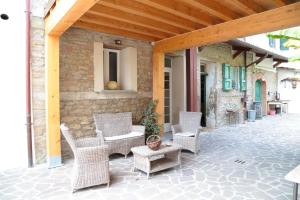 an outdoor patio with wicker chairs and a table at Re Piano appartamento Le Rondini in Modigliana