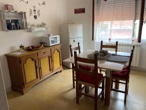 a kitchen with a table and a table and a refrigerator at finestra tra cielo e mare in Luni