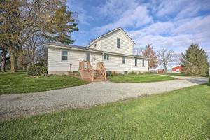 a white house with a porch and a driveway at Rise and Shine Farm in Goshen with BBQ and Fire Pit! in Goshen