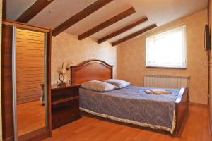 a bedroom with a bed and a window at Лісова казка in Slavske