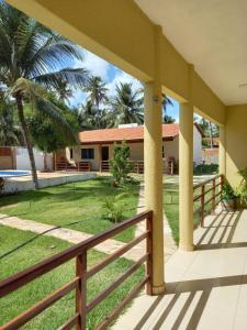 a view of a house with a fence and a yard at Pousada Villa Manduca in Amontada +26 photos
