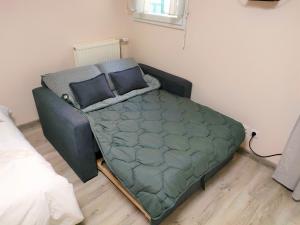 a bed in the corner of a room at Lovely flat nearby Paris fully redone with free parking on premises and balcony in Clichy