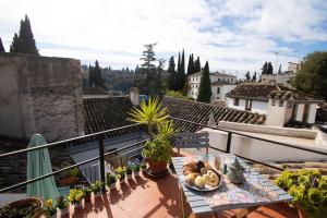 a balcony with a table with fruits and vegetables on it at Mirador Alhambra - 2 Private Terraces - Wifi - in Granada