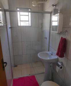 un bagno con doccia, lavandino e WC di Pousada Sol e Lua a São Thomé das Letras