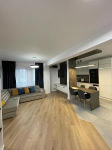 a large living room with a couch and a table at Adina Apartament in Gura Humorului