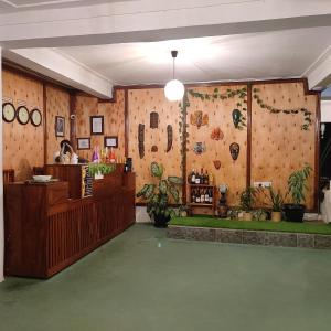 a lobby of a store with a wall with plants at Northern Pearl in Gulu