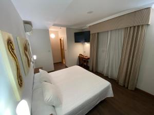 En eller flere senge i et værelse på Hotel Rural Finca Aldeola