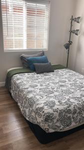 a bedroom with a large bed with a large window at Humble Home Santa Ana 2 in Santa Ana
