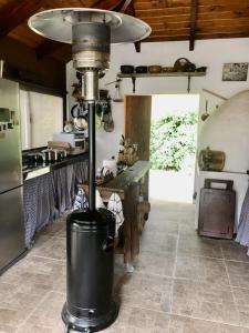 a kitchen with a heater in the middle of a room at Bebek B&B in Punta del Este
