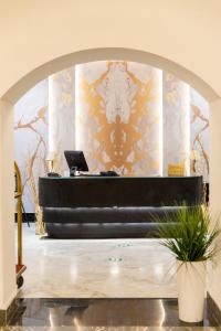 a lobby with a desk with a laptop on it at Hotel Majestic in Casablanca