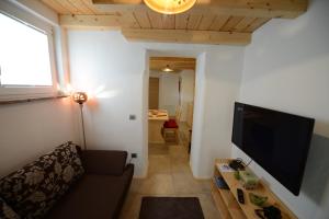 a living room with a couch and a flat screen tv at Apartments Mojca in Bled