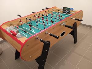 una mesa de futbolín de madera con una tabla grande con en Maison Plélauff, en Plélauff