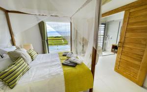 a bedroom with a bed and a large window at Villa Belle Galante in Les Basses