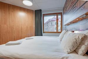 a large bed in a room with a window at Generator Stockholm in Stockholm