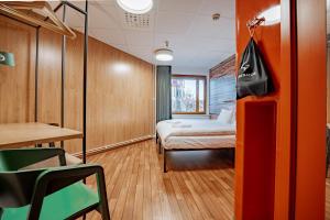 a room with a bed and a table and a chair at Generator Stockholm in Stockholm