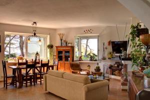 a living room with a couch and a dining room at Lacco Terrace Solarium in Ischia