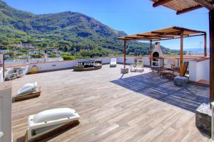 a rooftop deck with a view of a mountain at Lacco Terrace Solarium in Ischia