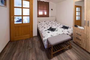 a bedroom with a bed and a chair and a door at Gordia organic winery in Hrvatini