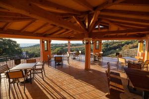 a large wooden deck with tables and chairs at Gordia organic winery in Hrvatini