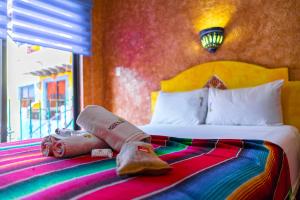 a hotel room with a bed with towels on it at Hacienda Maria Bonita Hotel in Playa del Carmen