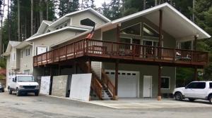 a large house with a porch and a balcony at Biker's Bungalow - Near Mendenhall Glacier and Auke Bay Offering DISCOUNT ON TOURS! in Mendenhaven