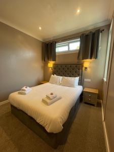 um quarto com uma cama com duas toalhas em The Skye Bridge Hotel em Kyle of Lochalsh