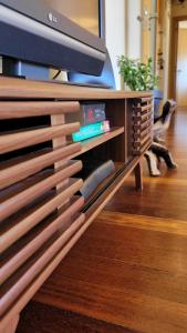 a wooden entertainment center with a tv on top at Casa da Praia in Vila Nova de Gaia
