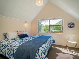 a bedroom with a bed and a window at Family Escape - Pauanui Holiday Home in Pauanui