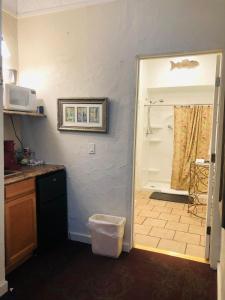 a kitchen with a door leading to a shower at Historic Palace Hotel in Silver City +66 photos