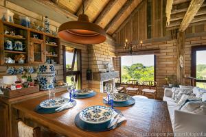 uma sala de jantar com uma mesa com pratos azuis e brancos em Cabana Uruguaia Pet friendly em Torres