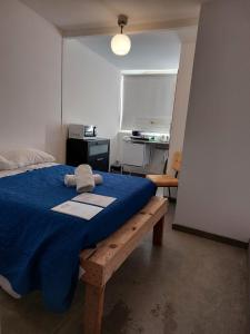 a bedroom with a bed with a blue blanket at Casa Vale in Lisbon