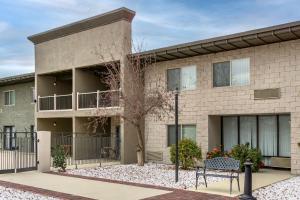 a building with two benches in front of it at Best Western PLUS Lake Front Hotel in Moses Lake