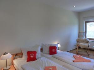 a bedroom with two beds with red pillows at Ferienwohnung NH5 in Hirschburg