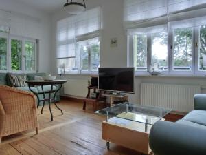 a living room with a couch and a tv at Strandstraße 60 Ferienwohnung S12 in Graal-Müritz