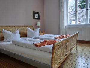 a bedroom with a bed with two robes on it at Strandstraße 60 Ferienwohnung S14 in Graal-Müritz