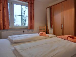 a bedroom with two beds with towels on them at Ferienwohnung P3 in Graal-Müritz