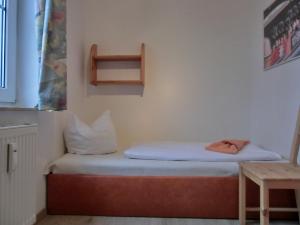 a small room with two beds and a table at Ferienwohnung P3 in Graal-Müritz