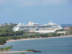 a cruise ship is docked on the beach at Amazing Beach View Apartments in Castries