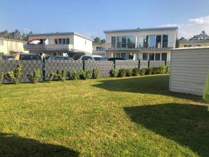 einen Zaun vor einem Hof mit Häusern in der Unterkunft Ferienwohnung KWi 73 EG "grüne Oase" in Graal-Müritz