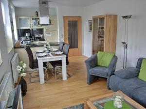 a living room and kitchen with a table and chairs at Ferienwohnung L36 in Graal-Müritz